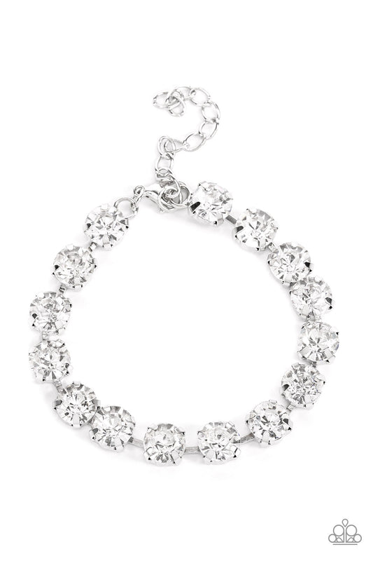 Featuring pronged silver fittings, an oversized row of glassy white rhinestones connect around the wrist for a glamorous pop of glitz. Features an adjustable clasp closure.