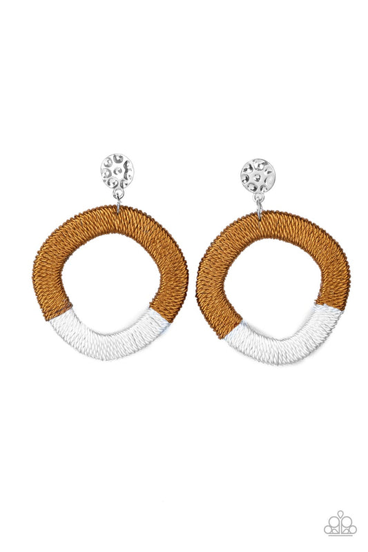 A hammered silver disc gives way to a wooden frame decoratively wrapped in shiny white and brown threaded accents, creating a colorful lure. Earring attaches to a standard post fitting.