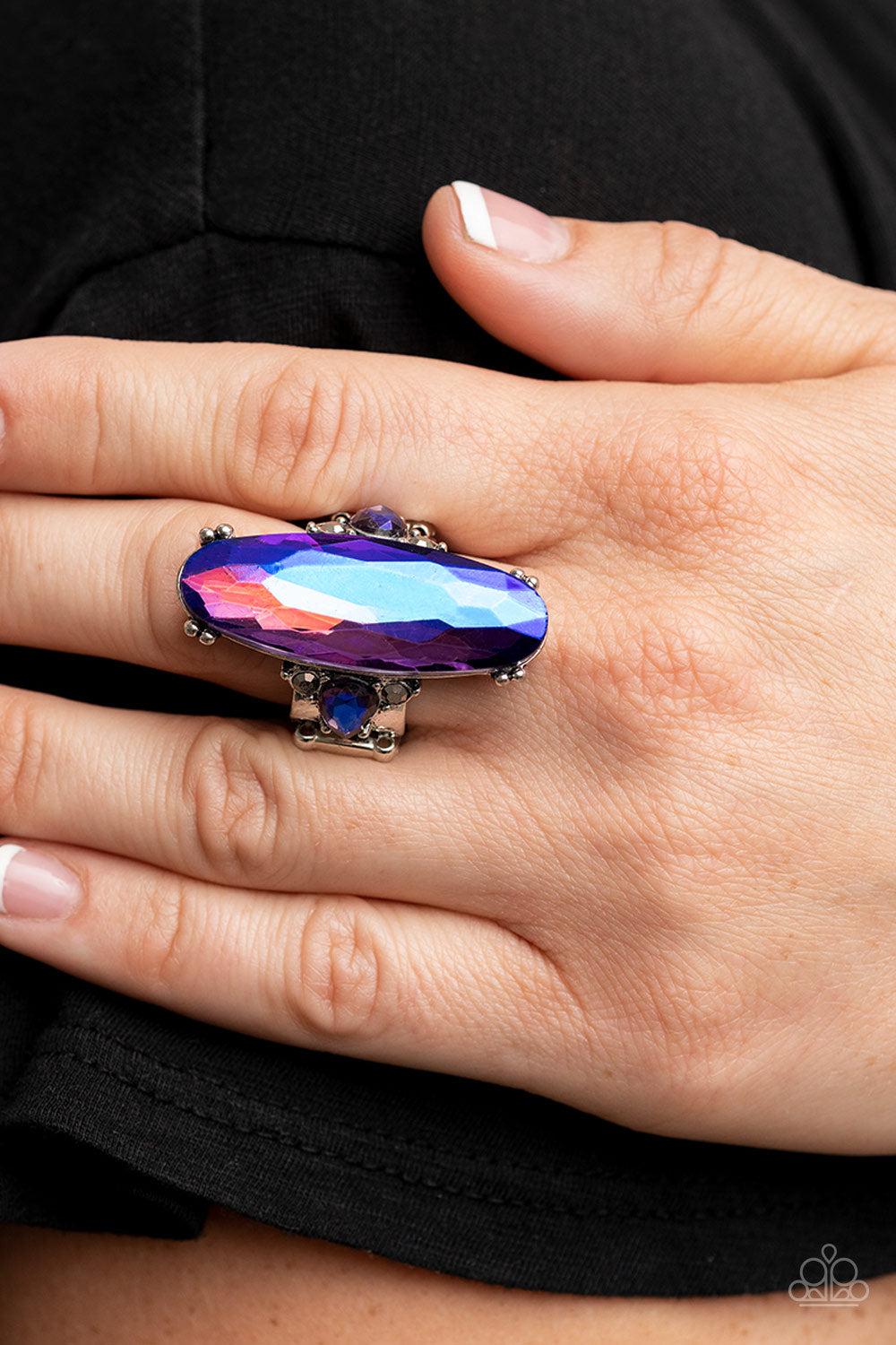 Featuring a stellar purple UV finish, an oversized blue oval gem sparkles between two dainty UV rhinestones atop a hematite dotted silver band for an out-of-this-world shimmer atop the finger. Features a stretchy band for a flexible fit.