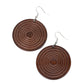 A shiny brown wooden disc is engraved in circular details, resulting in a dizzying pop of color. Earring attaches to a standard fishhook earring.