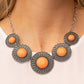 Dotted with bubbly orange beads, silver discs spinning with swirly petal motifs gradually increase in size as they link below the collar for a statement-making floral fashion. Features an adjustable clasp closure.