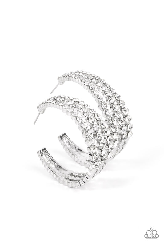 Cascading layers of sparkling white rhinestones plunge into flattened silver plates creating a stunning eye-catching hoop earring. Earring attaches to a standard post fitting. Hoop measures approximately 2" in diameter.