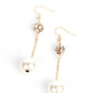An oversized white pearl swings from the bottom of a dainty gold chain that is suspended from a white rhinestone encrusted gold bead, resulting in a timeless twist. Earring attaches to a standard fishhook fitting.  Sold as one pair of earrings.