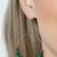Infused with earthy wooden accents, studded silver rings and pieces of green shell-like pebbles alternate along a dainty wire hoop for a tropical inspiration. Earring attaches to a standard fishhook fitting.