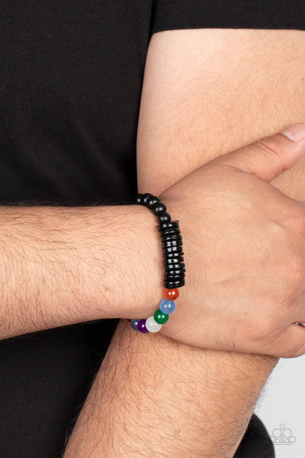 Infused with black wooden discs and beads, a glassy collection of rainbow-colored beads are threaded along stretchy bands around the wrist for an adventurous pop of color.