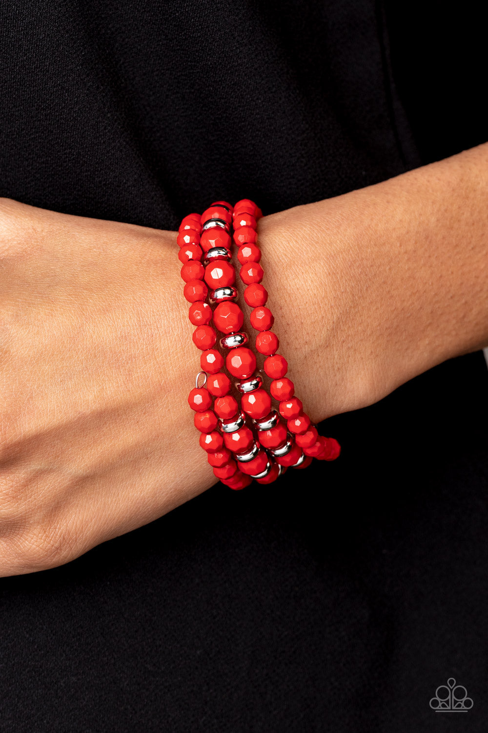 Accented with silver discs, a mismatched assortment of faceted Poinciana beads are threaded along a wire that coils around the wrist, creating a vivacious infinity wrap bracelet.