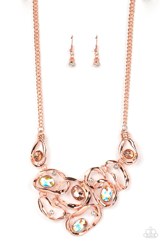 Warped shiny copper frames asymmetrically curl around dainty white rhinestones and peach and iridescent gem accents, interlocking into a contemporary statement piece below the collar. Features an adjustable clasp closure. Due to its prismatic palette, color may vary.