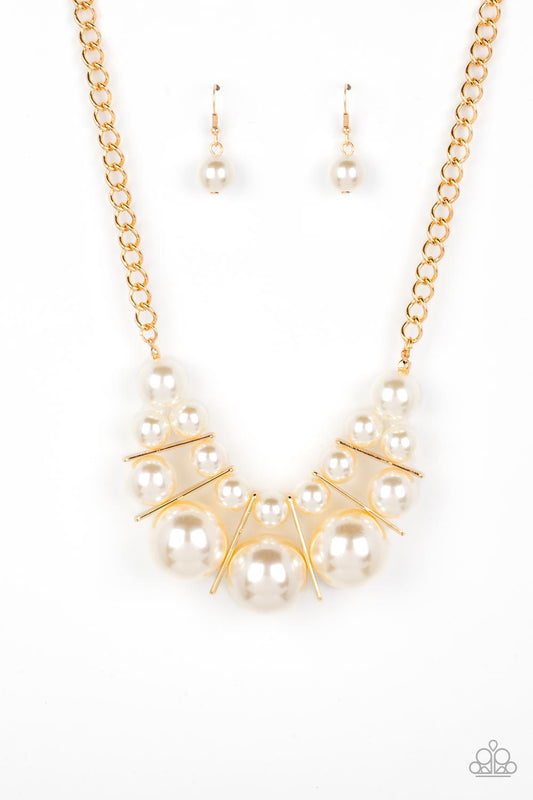 Separated by rectangular gold frames, bubbly rows of classic and oversized white pearls are threaded along invisible wires at the bottom of a chunky gold chain for an effervescent explosion below the collar. Features an adjustable clasp closure.  Sold as one individual necklace. Includes one pair of matching earrings.