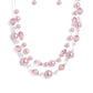 Baby pink beads brushed in a pearlescent finish are strung through glistening silver wires in a refined display. Infused with transparent and baby pink beads, the layered clusters add a fashionable twist to the classic pearl design. Features an adjustable clasp closure.  Sold as one individual necklace. Includes one pair of matching earrings.