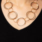 A shimmering collection of thin gold hoops in varying sizes interlock and coalesce down the neckline for a refined monochromatic statement piece. Features an adjustable clasp closure.  Sold as one individual necklace. Includes one pair of matching earrings.