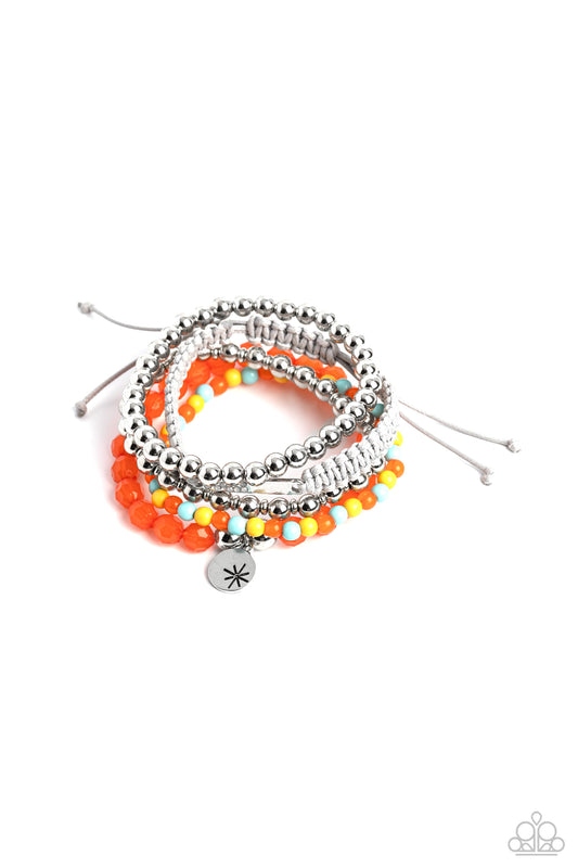 Strands of Orange Tiger, Waterspout, and Samoan Sun beads are threaded along elastic stretchy bands to create a stack of bracelets. The varying opacities of each bead adds depth to the design, as a strand of silver beads adds metallic sheen. A silver disc stamped with a star offers a whimsical accent, as a silver bar dotted with opalescent rhinestones is tied to another bracelet created with tan cording and a sliding knot closure.