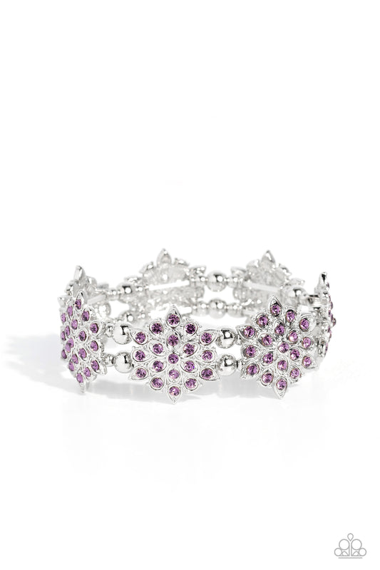 Delicate layers of silver teardrop frames dotted with glistening purple rhinestones combine to create a stunning snowflake-like shape. Infused along elastic stretchy bands around the wrist, the icy frames combine with silver beads in varying sizes for a monochromatic statement.