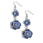 Dotted with dainty blue iridescent gem centers and navy rhinestone details, intricate 3D silver flowers, adorned in Persian Jewel shades, link into a whimsical, glitzy lure. Earring attaches to a standard fishhook fitting. Due to its prismatic palette, color may vary.