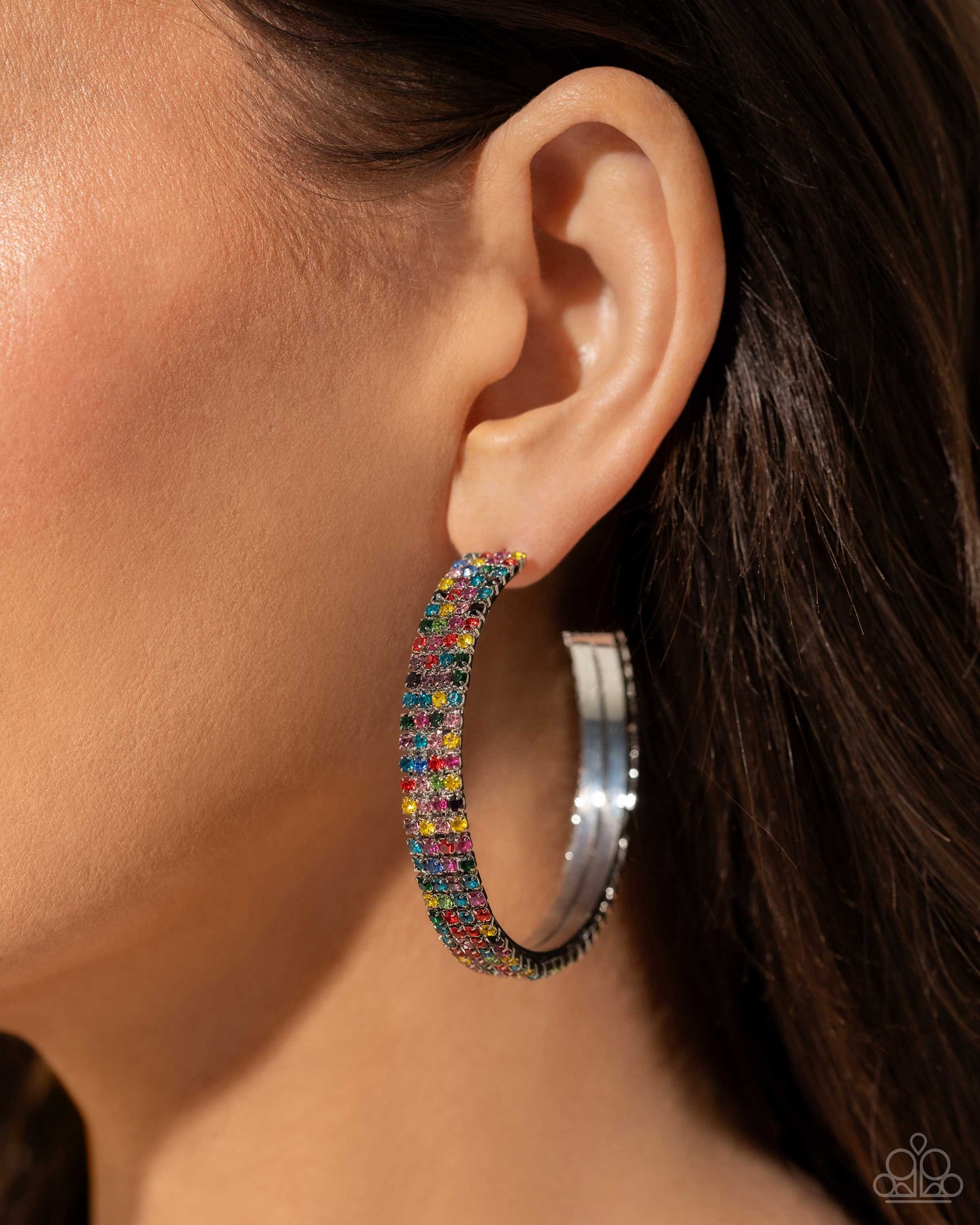 Set in silver square fittings, row after row of multicolored rhinestones are embellished around a silver hoop for a dazzling design. Earring attaches to a standard post fitting. Hoop measures approximately 2" in diameter.