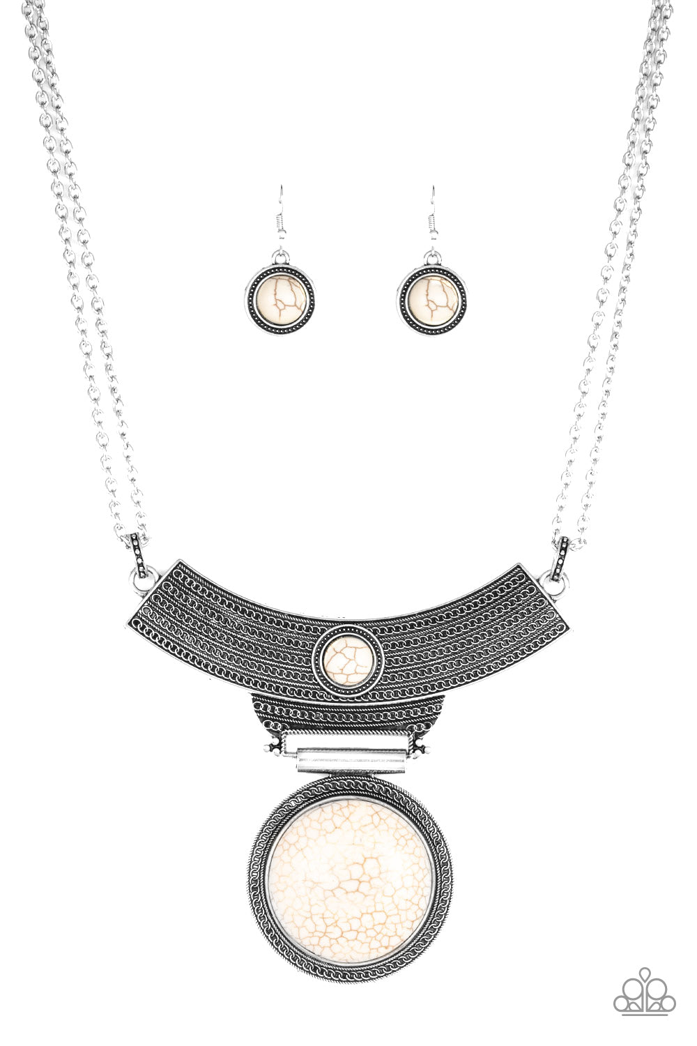 An antiqued silver plate, adorned in rippling circular textures, swings from the bottom of a pair of doubled silver chains. The ornate plate gives way to a dramatic white stone pendant bordered by tribal inspired patterns for a statement-making finish. Features an adjustable clasp closure.