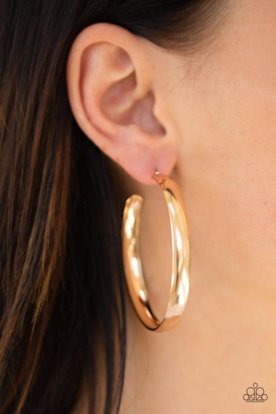 Brushed in a high sheen finish, a thick gold hoop curls around the ear for a classic look. Earring attaches to a standard post fitting. Hoop measures 2 1/4" in diameter.