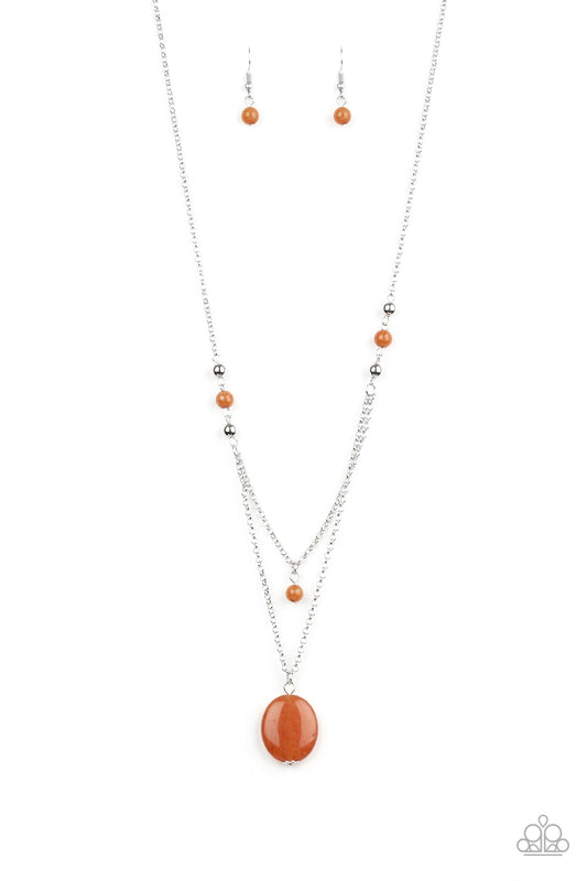 Rows of dainty silver and glassy orange beads give way to two shimmery silver chain layers. A dainty orange bead swings from the uppermost strand, while a glassy orange stone pendant swings from the lowermost chain for a stacked look. Features an adjustable clasp closure.